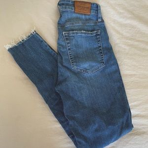 High Waisted Un-Hemed Medium/Dark Jean w/ Stretch